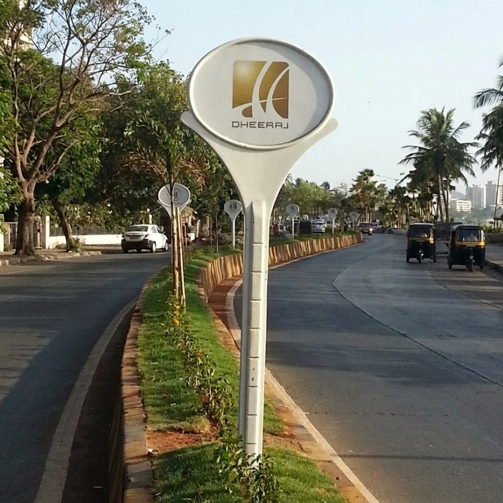 FRP Lollipop Signage Board FRP lollipop signage boards installed in a row along a road divider for a real estate project
