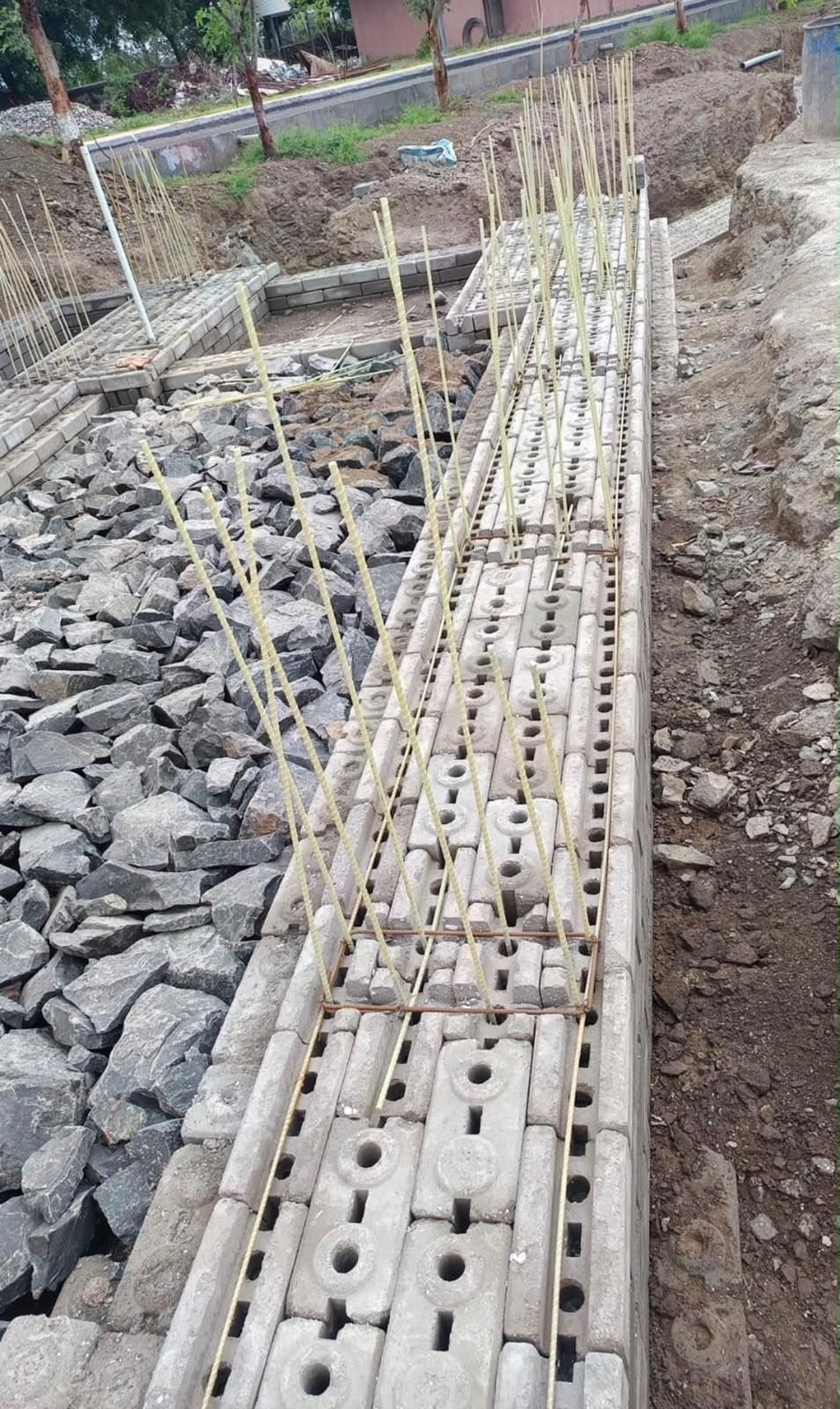 GFRP Rebar in India: Approvals, Uses, Standards & Market Outlook Grandform Fiber GFRP rebars placed in interlocking blocks for a compound wall